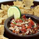 Salsa in bowl surrounded by chips